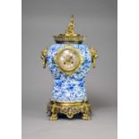 A Chinese taste brass mounted and Delft mantel clock