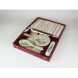 A cased four piece silver and enamel dressing table set