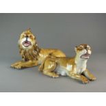 A pair of Meissen models of a lion and lioness