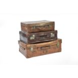 Three vintage graduated leather suitcases