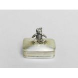 A sterling silver pill box with teddy bear finial