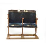 A twin-set of upholstered cast-iron theatre or cinema seats