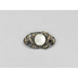 An Art Nouveau white metal mother of pearl set brooch