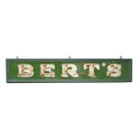 A very large glass shop front sign for Bert's Fish Bar, London