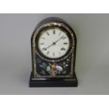 A 19th century arched, ebonised, mantel clock, probably with an American, 8-day movement