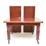A Victorian mahogany wind-out dining table with two additional leaves