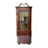 A 19th century mahogany veneered floor standing corner cupboard