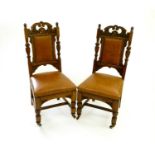 A set of six late Victorian carved oak leather upholstered dining chairs