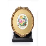 A framed English porcelain floral painted plaque