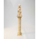 A resin model of a child reading a book, 46cm high, on a resin pedestal (2)