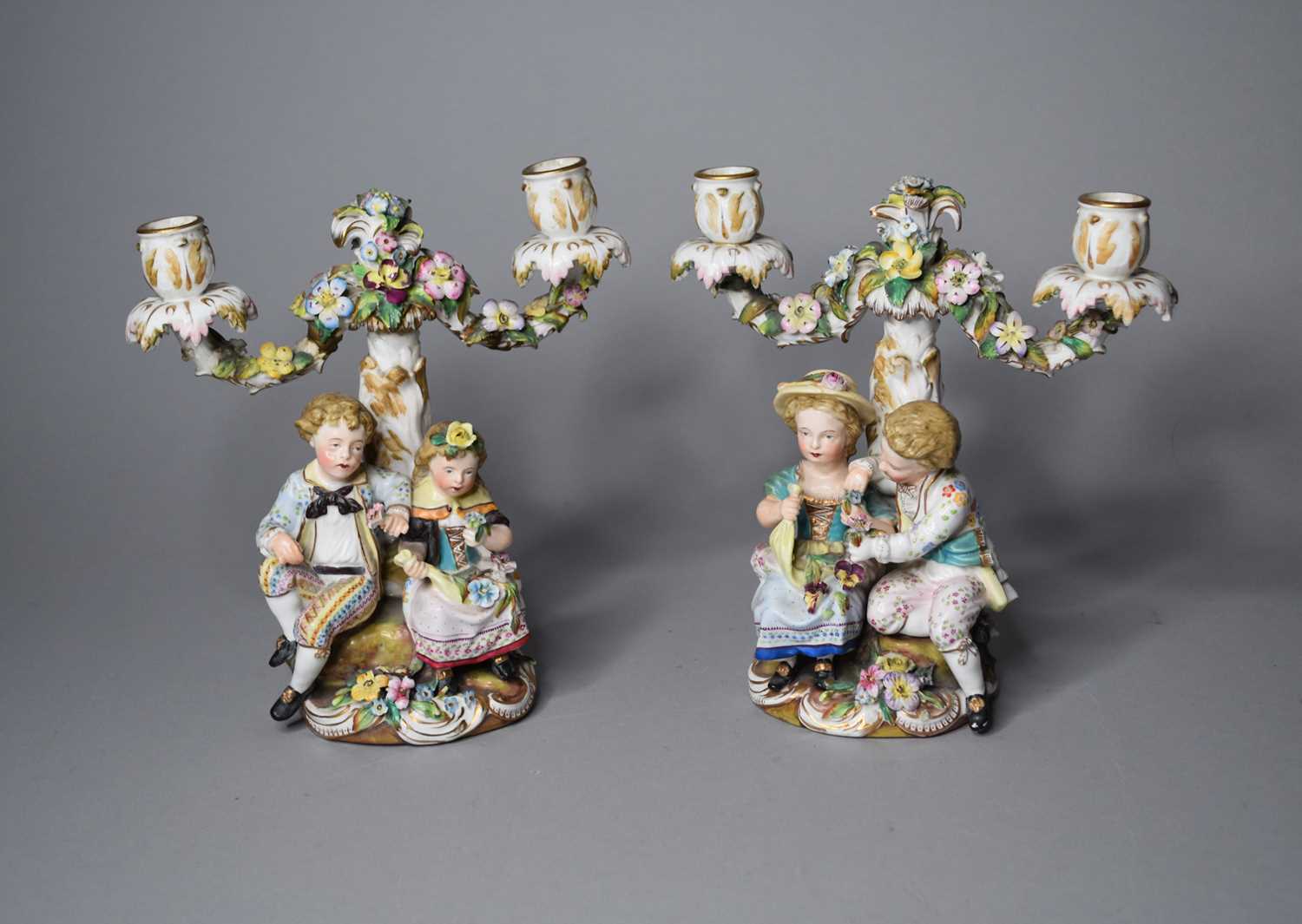 A pair of John Bevington porcelain figural candelabra