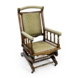 An American type upholstered mahogany rocking chair