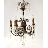 A reproduction gilt metal and cut glass six light chandelier