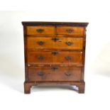 A George II walnut veneered chest of drawers