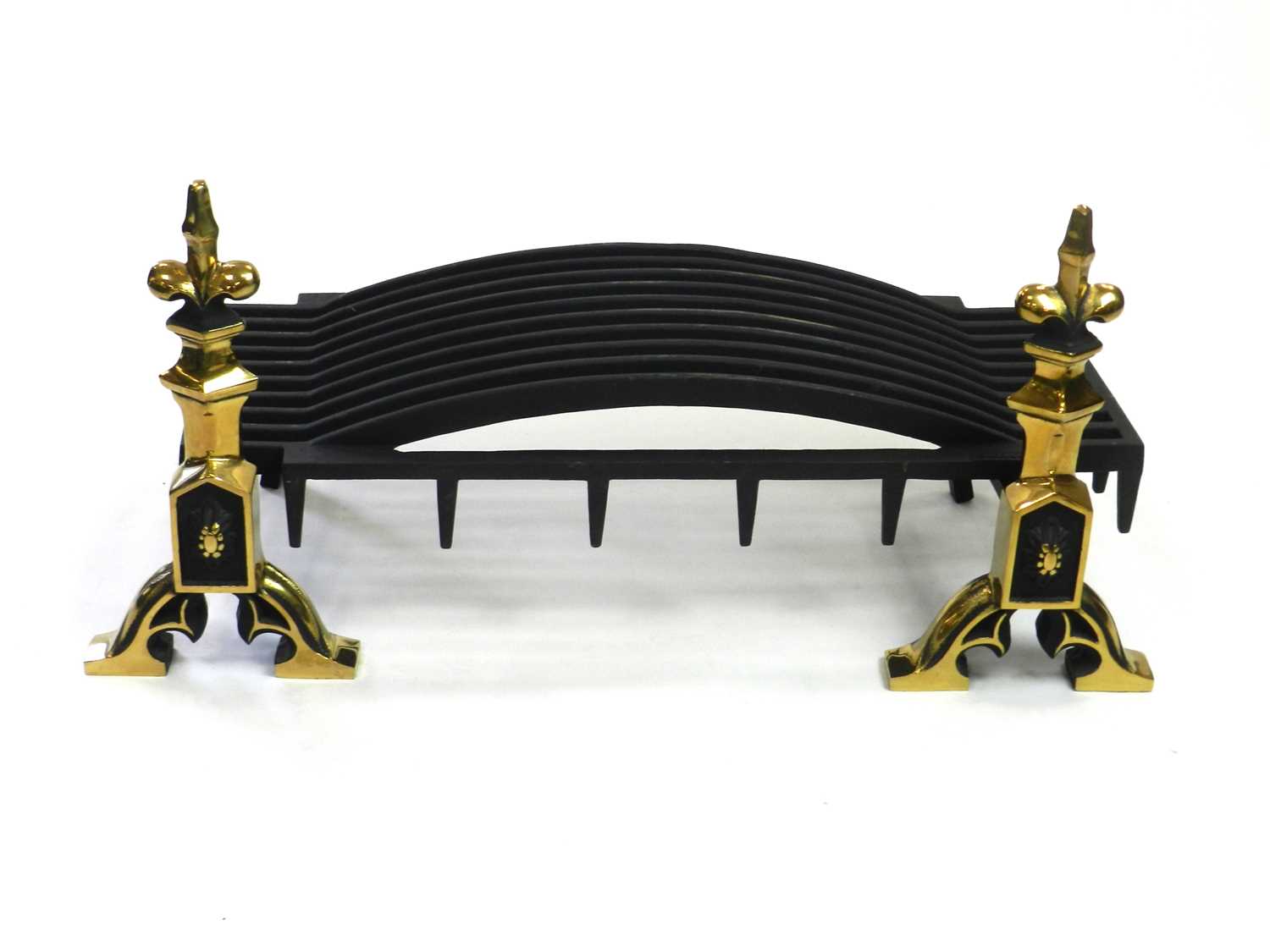 A pair of brass and cast iron fire dogs and fire grate