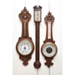 Two aneroid barometers and a stick barometer