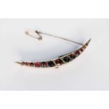 A 9ct gold graduated garnet crescent brooch