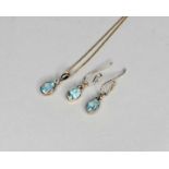 An oval mixed cut blue topz pendant and earrings