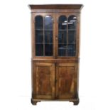 A 19th century oak and mahogany floor-standing corner cupboard