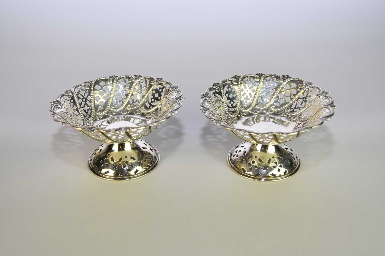 A pair of silver pierced pedestal bon bon dishes