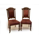 A set of 8 carved oak Victorian dining chairs, with hide covered seats and backs