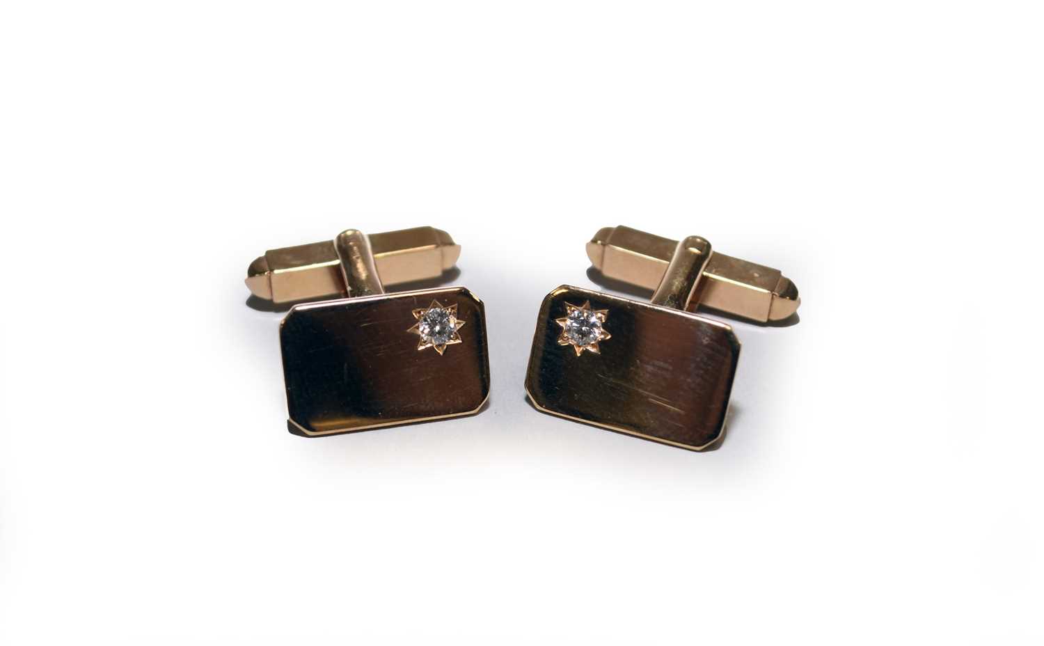 A pair of yellow metal diamond set cufflinks