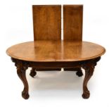 A Victorian, honey-coloured, figured oak extending dining table