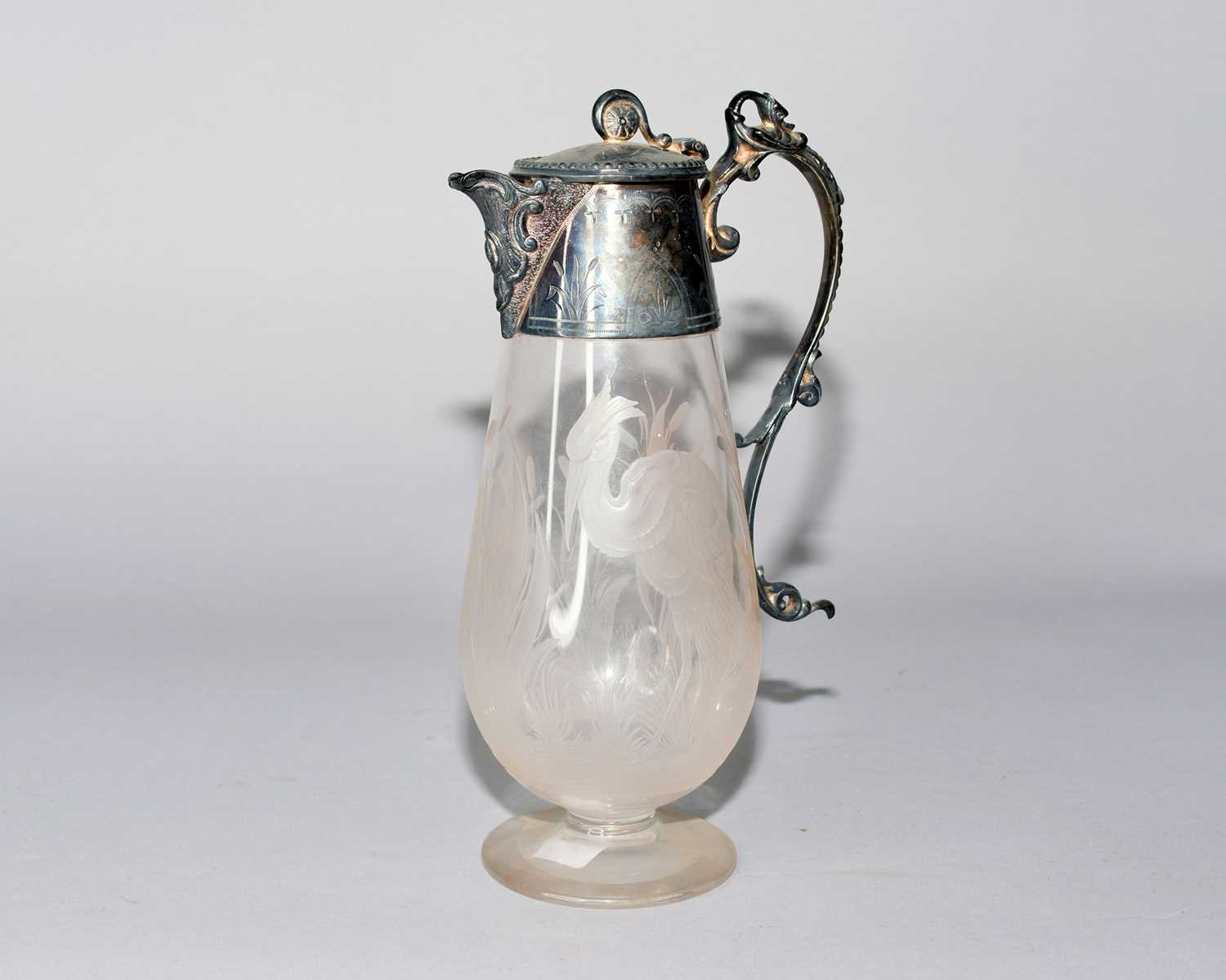 An electroplated mounted glass jug