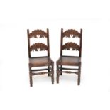 A set of four 17th century style carved oak side chairs