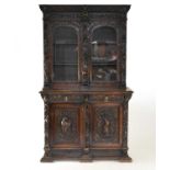 A 19th century Flemish style carved oak bookcase cabinet