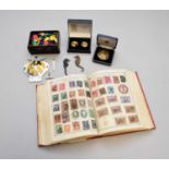 A stamp album and medallions