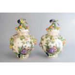 A pair of Saxonian porcelain (Carl Thieme Potschappel) vases and covers