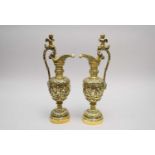 A pair of cast brass wine ewers and a pair of brass and ceramic aesthetic movement candlesticks