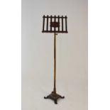 A late Victorian cast iron, brass and mahogany music stand