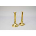 A near pair of brass candlesticks