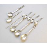 A collection of silver and white metal spoons
