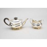 A silver teapot and sugar bowl