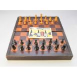 An Edwardian inlaid mahogany games box with a boxwood and ebonised chess set