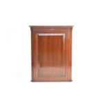 A George III mahogany hanging corner cupboard