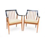 A set of eight Scandinavian parcel ebonised teak armchairs