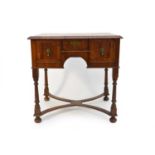 A William & Mary style oyster veneered walnut lowboy