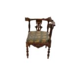 A 19th century Flemish style carved oak upholstered elbow chair
