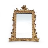 A rococo revival giltwood overmantel mirror