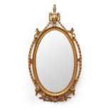 A Regency revival giltwood oval mirror in the Adam style