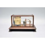 An early 20th century oak barograph with bevelled glass top