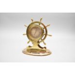 A brass novelty ship's wheel desk barometer