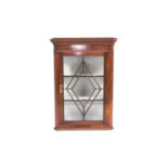 A George III glazed mahogany hanging corner cupboard