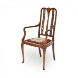 An Edwardian inlaid mahogany open armchair