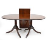 A reproduction mahogany twin-pedestal dining table
