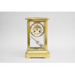A 20th century brass, four glass clock,